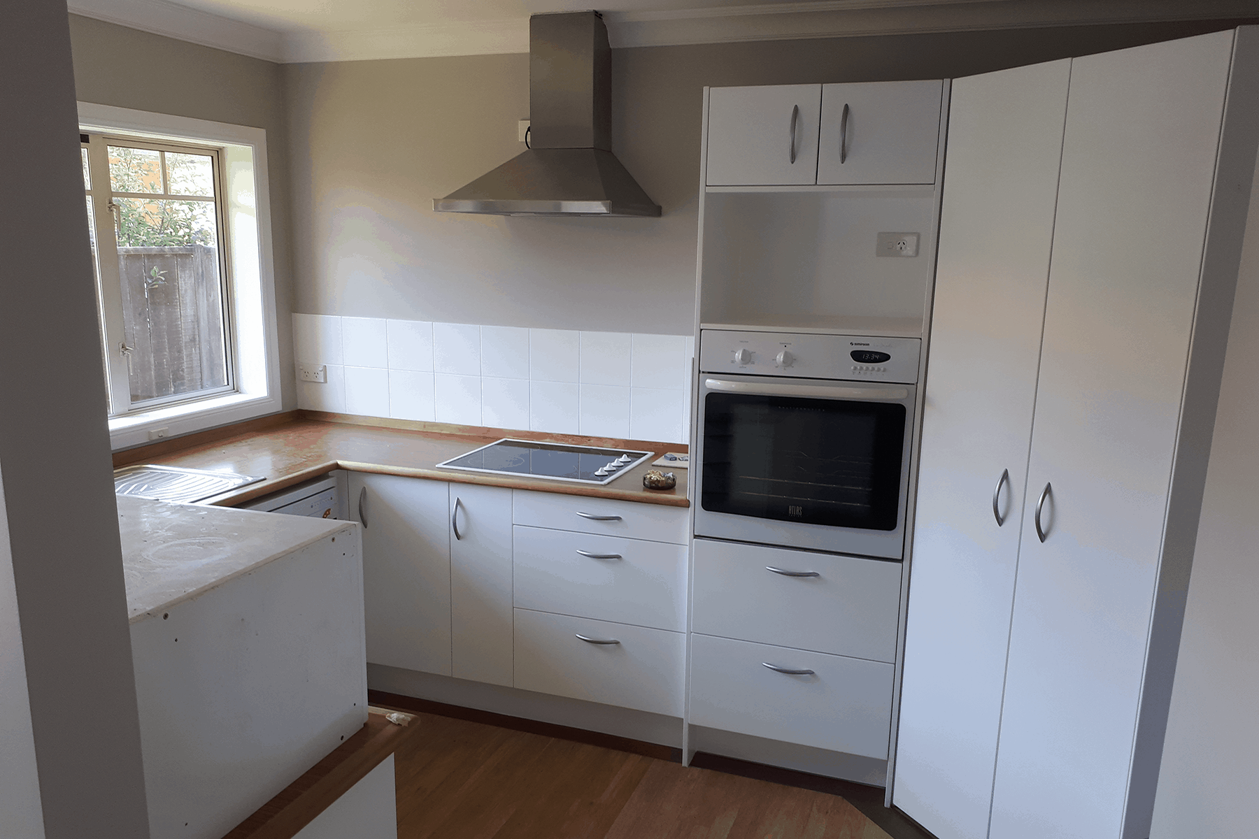 resurfaced-kitchen-wooden-bench-white-cabinets